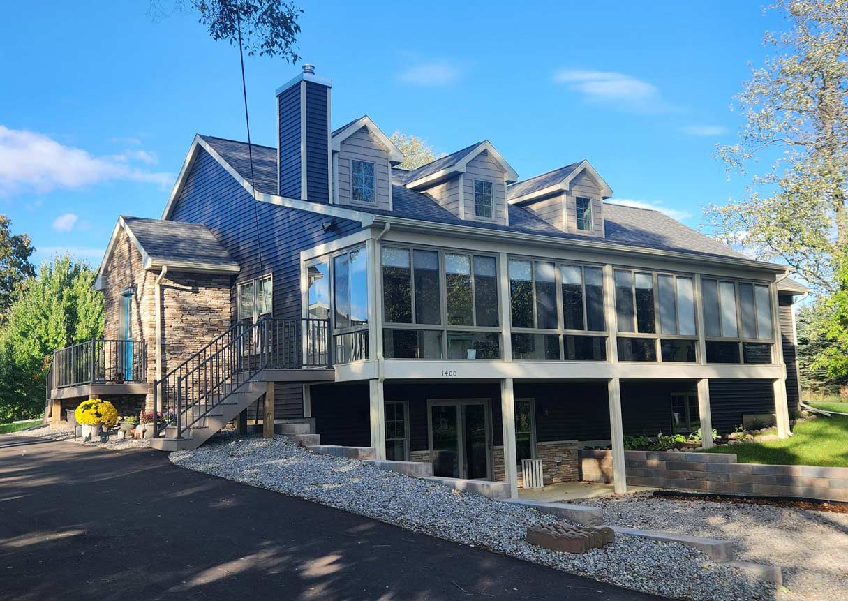 Front elevation of custom built and finished Cape Cod style home by Cornerstone Custom Homes in DeWitt, MI